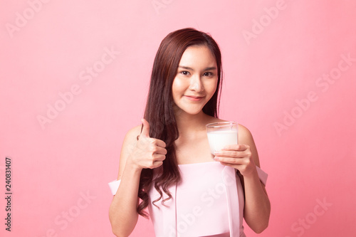 Healthy Young Asian woman drinking milk show thumb up