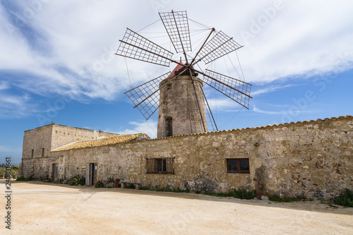 Typical old windmill now housing a salt museum (Museo del Sale) at Trapani salt flats, Sicily, Italy