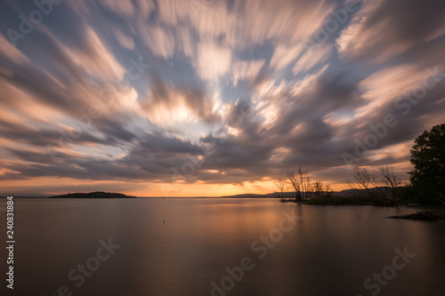 Canvas Print Beautiful wide angle, long exposure view of a lake at sunset, with an huge sky w