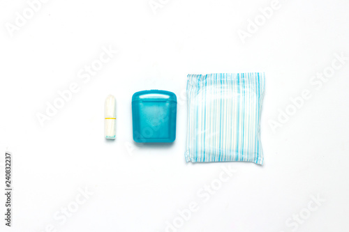 Feminine hygiene tampons, box for shipping and storage and sanitary pad on a white background. Concept of feminine hygiene during menstruation, choice between pads and tampons. Flat lay, top view
