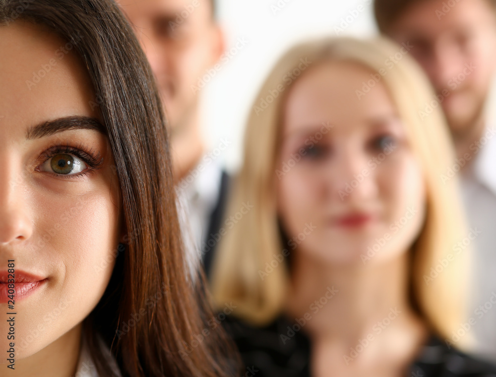 Group of smiling people stand in office looking Group of smiling people stand in office looking