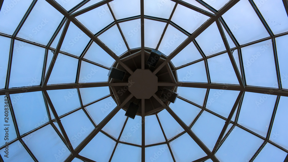 Glass dome in the sky. Abstract view of the window on the ceiling.