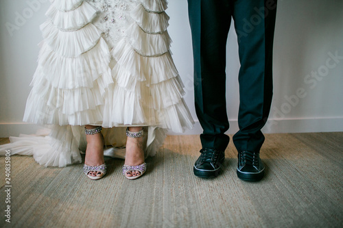 wedding couple standing showing shoes
