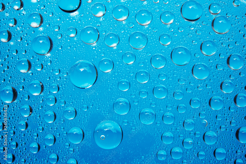 Water Droplets On Blue Background.