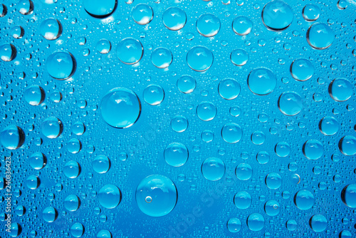 Water Droplets On Blue Background.