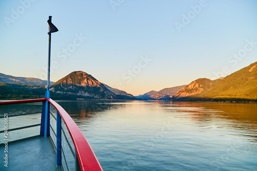 boat at sunset on river facing forward