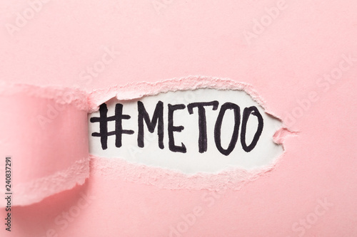 Hashtag METOO under torn color paper photo