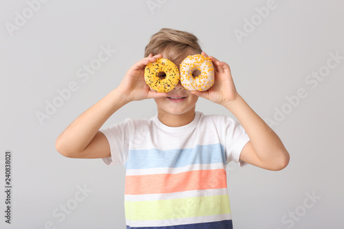 Cute little boy with donuts...
