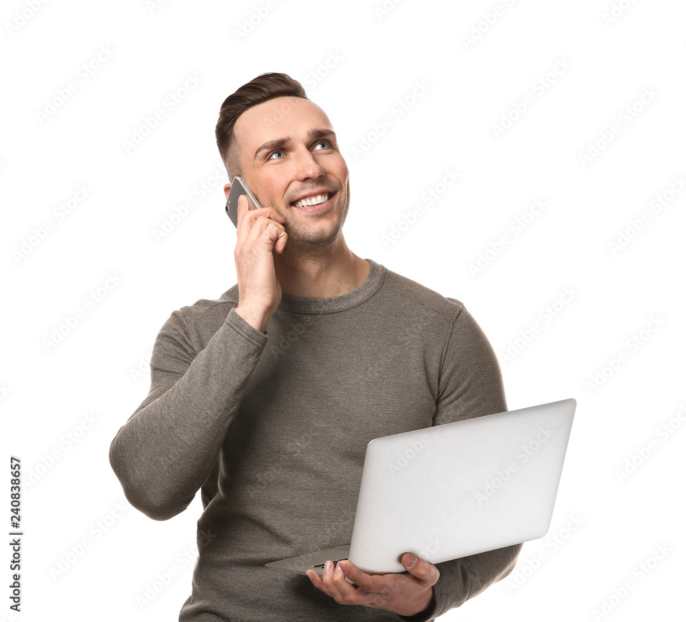 Young man with laptop talking by phone on white background Young man with laptop talking by phone on white background