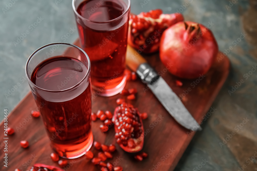 Glasses of tasty pomegranate juice on table Glasses of tasty pomegranate juice on table