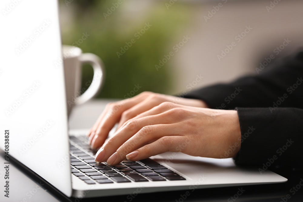 Young woman working with laptop in office, closeup Young woman working with laptop in office, closeup