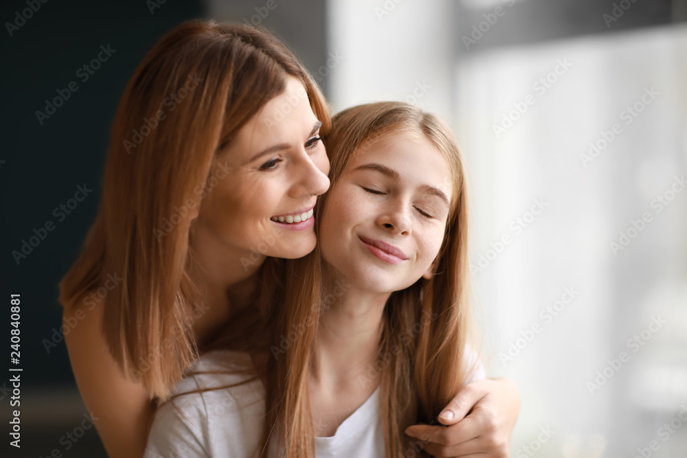 Portrait of happy mother and daughter near window Portrait of happy mother and daughter near window