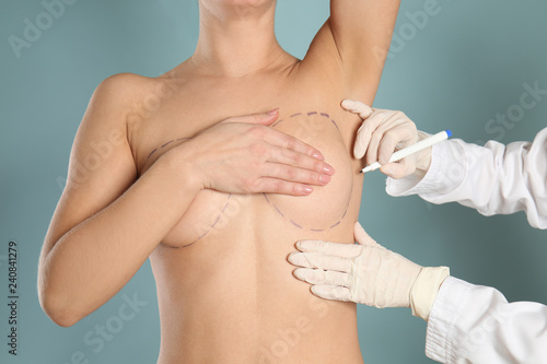 Doctor drawing marks on fem...