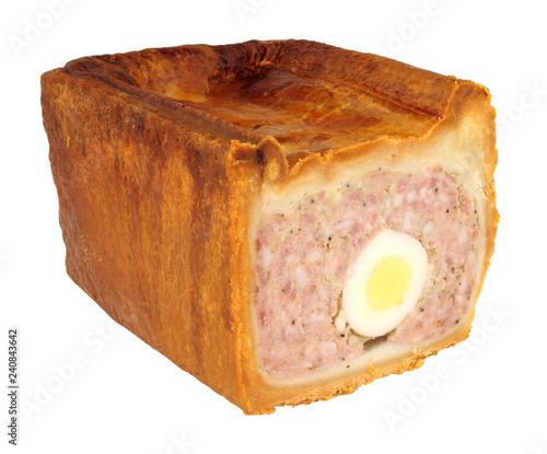 Traditional English savoury gala egg pork pie with crusty hot water pastry isolated on a white background