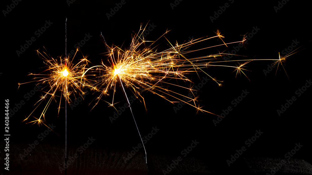Christmas sparkler isolated on black background. Bengal fire