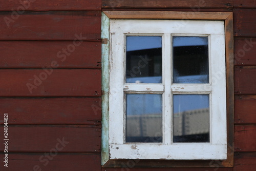 Old white window, red wood wall. 