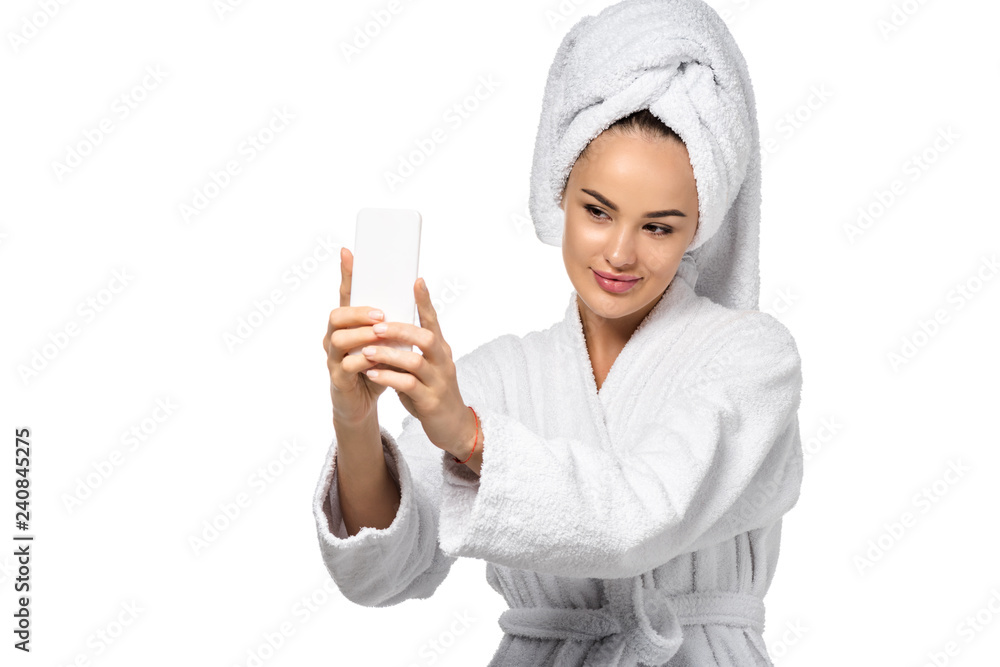 attractive girl in bathrobe with towel on head taking selfie isolated on white attractive girl in bathrobe with towel on head taking selfie isolated on white
