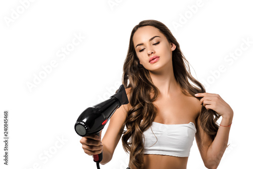 beautiful girl holding hair dryer isolated on white