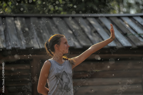 Happy teen girl in the summer rain