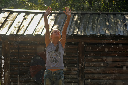 Фотография Happy teen girl in the summer rain