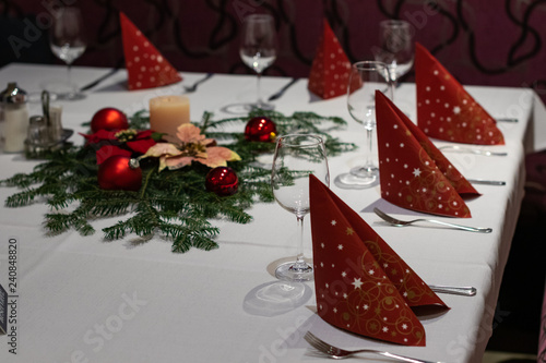 Christmas decoration on a restaurant table. wine glass, red napkins;