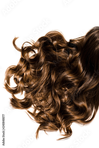 cropped view of long curly brown female hair isolated on white