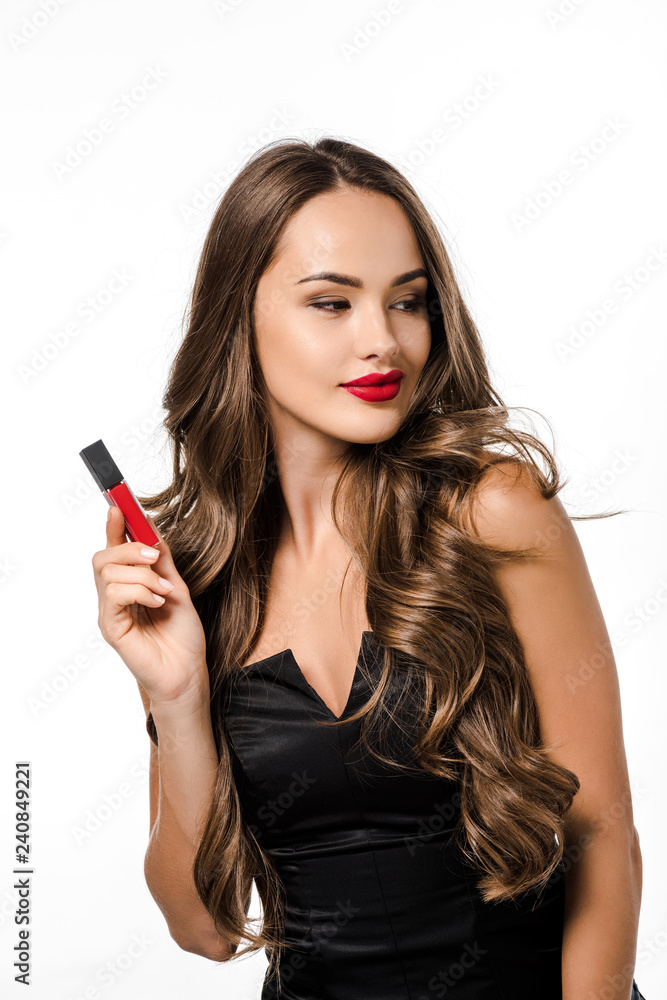 attractive model in black dress smiling and holding liquid lipstick isolated on white attractive model in black dress smiling and holding liquid lipstick isolated on white
