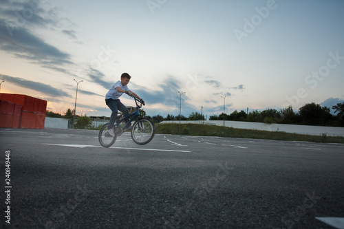 Little boy doing tricks jumping riding bike