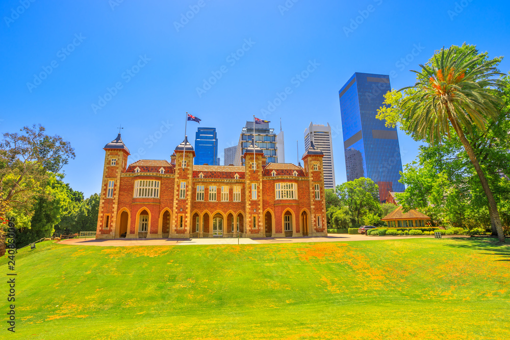 Fototapeta premium Government House east front in Perth, Western australia. The residence of Governor of WA is located between St Georges Terrace, Stirling Gardens and Supreme Court Gardens. Blue sky with copy space.
