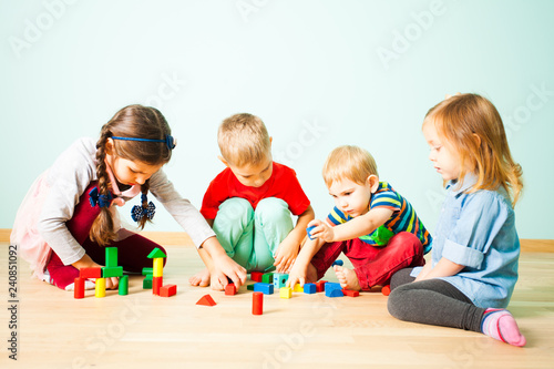 Kids playing with wooden blocks at kindergarten © oksix
