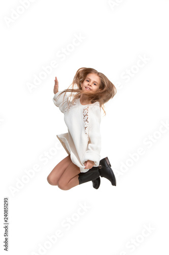 Cute little girl jump. Studio shot. White background. Kids fashion concept