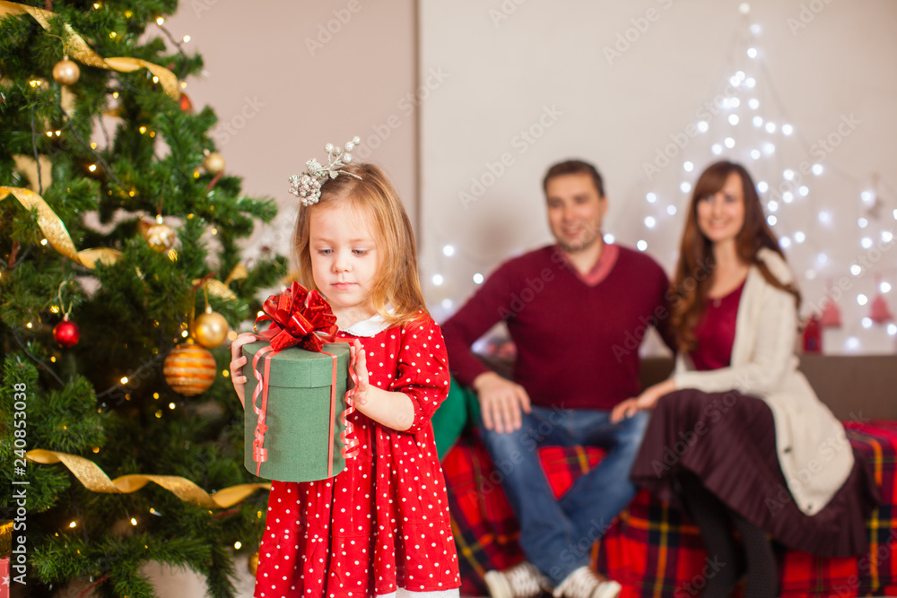 Happy family with daughter decorate Christmas tree Happy family with daughter decorate Christmas tree