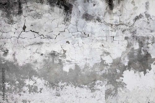 Cracked concrete wall covered with gray cement surface. Old grunge textures b...