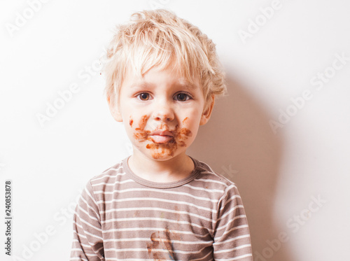Boy eated chocolate and have dirty face