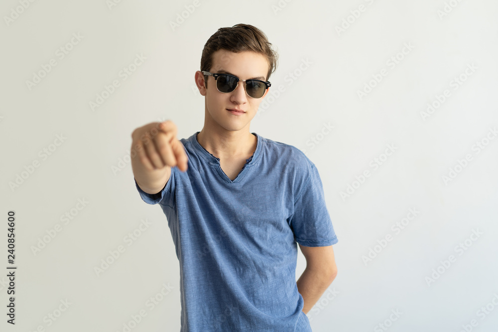 Content young man in glasses pointing at camera. Confident guy gesturing hand and looking at camera. Choice concept Content young man in glasses pointing at camera. Confident guy gesturing hand and looking at camera. Choice concept