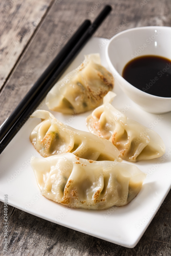 Dumplings or gyoza and soy sauce on wooden table. Close up Dumplings or gyoza and soy sauce on wooden table. Close up