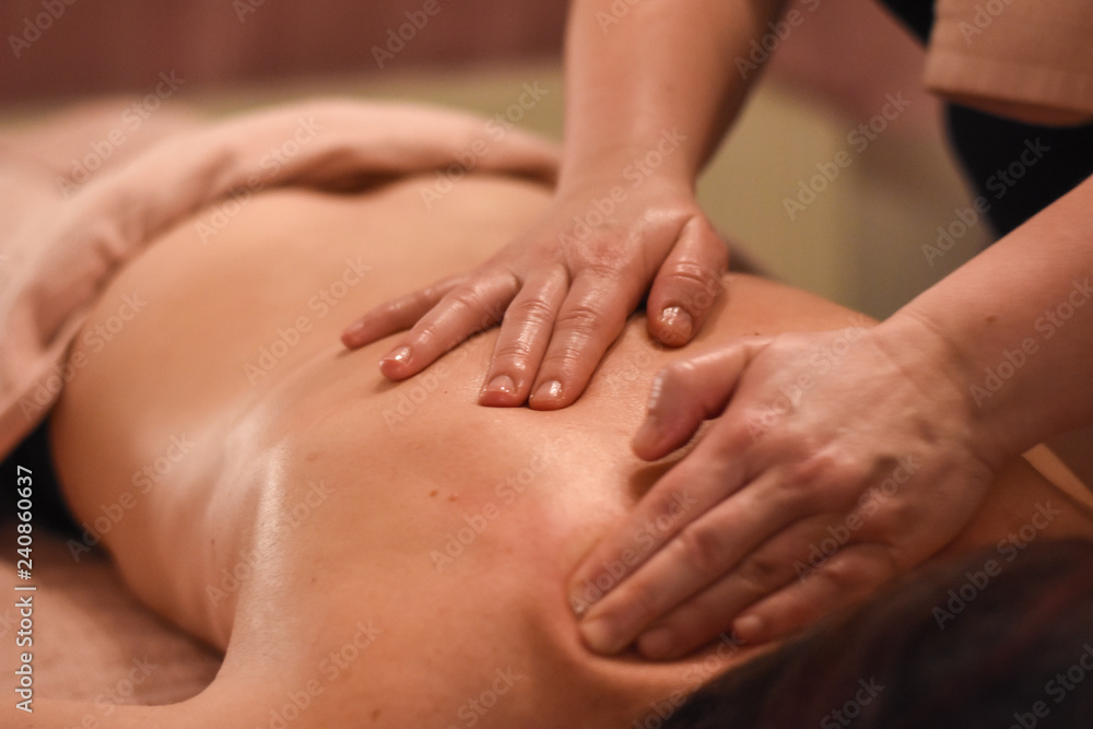 Woman having back massage. Body care, woman having massage in spa Woman having back massage. Body care, woman having massage in spa
