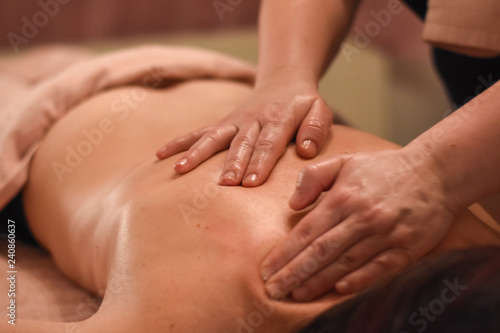 Woman having back massage. Body care, woman having massage in spa