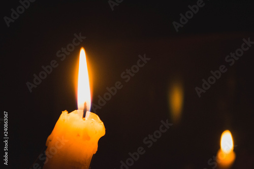 Flame of one burning candle close up 
