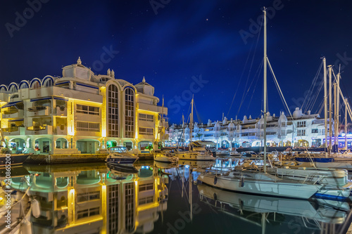 Benalmadena mediterranean port village. Yacht harbor, marina pier and boat, dock yachts and vessels in Benalmadena, Malaga photo