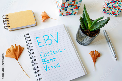 EBV Epstein–Barr virus written in a notebook on white table photo