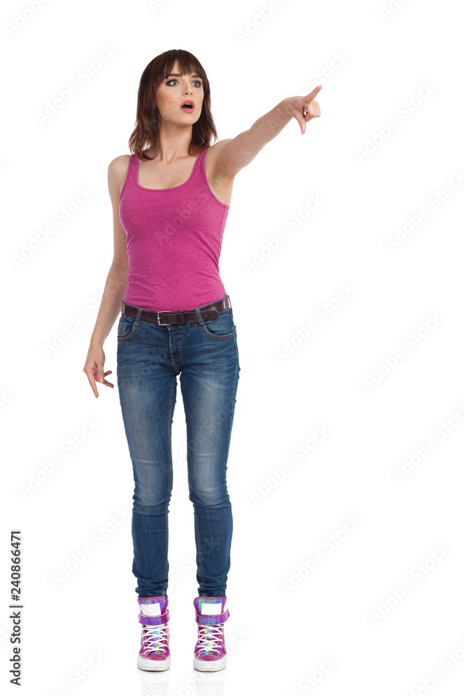 Curious Young Woman Is Looking Away And Pointing Curious Young Woman Is Looking Away And Pointing