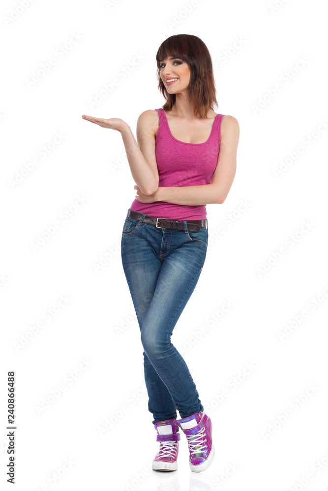 Smiling Young Woman Is Presenting And Looking At Camera Smiling Young Woman Is Presenting And Looking At Camera