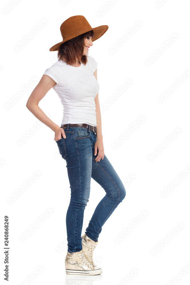 Beautiful Woman In Gold Sneakers And Brown Hat. Side View. Beautiful Woman In Gold Sneakers And Brown Hat. Side View.