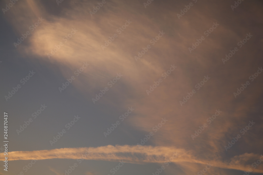 The sun rays illuminate the sky with clouds. We see the background of the sky of natural color as in the picture. This image of a beautiful sky and white clouds pleases all people. The sun rays illuminate the sky with clouds. We see the background of the sky of natural color as in the picture. This image of a beautiful sky and white clouds pleases all people.