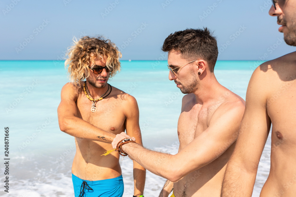Group of friends walking on he beach together Group of friends walking on he beach together