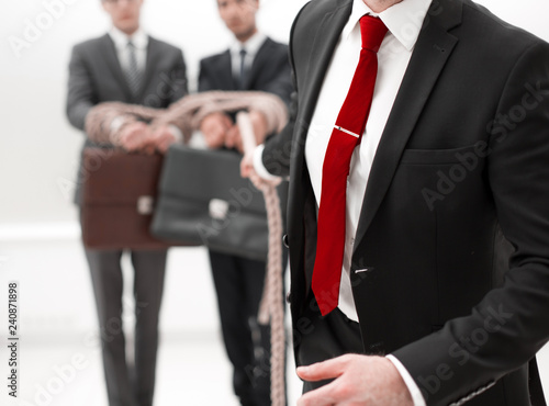 Unrecognizable business people connected with each other with a rope © ASDF