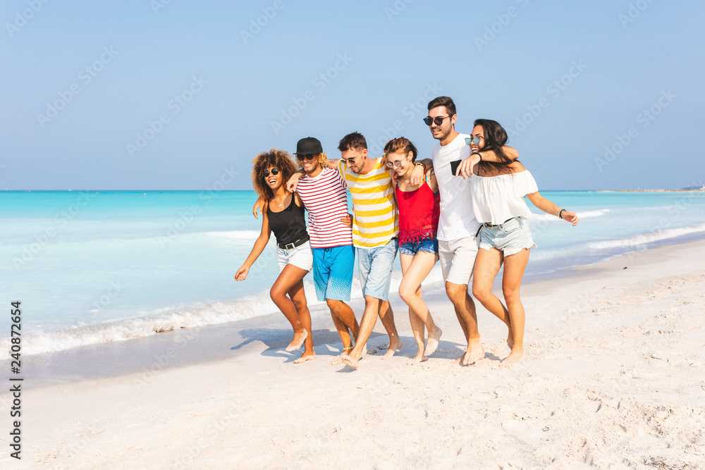 Group of friends walking on the beach Group of friends walking on the beach