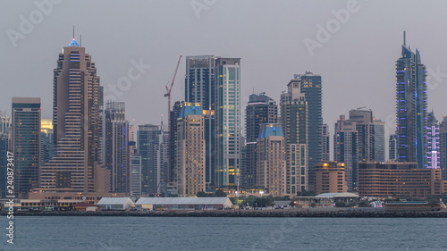 Dubai Marina skyline day to night timelapse as seen from Palm Jumeirah in Dubai, UAE.