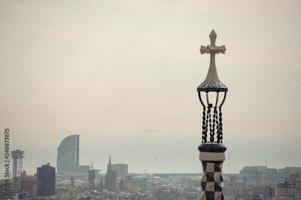 BARCELONA, SPAIN - NOVEMBER 4, 2018: Top view of Park Guell in the background if morning mist and grey sky
